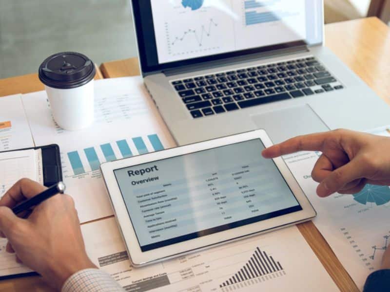 Small business owner reviewing automation tool pricing on a laptop